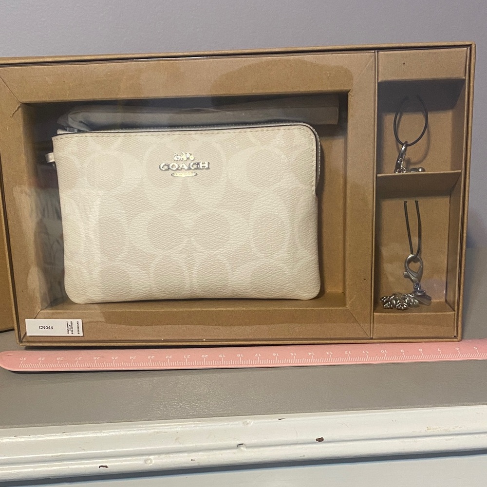 BNIB Coach wristlet with charms